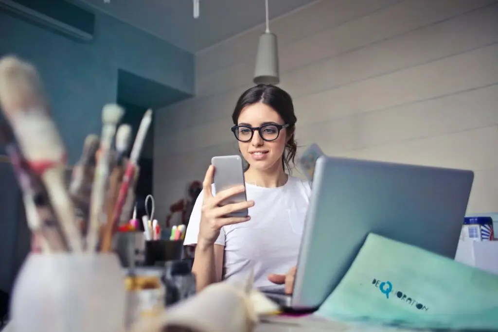 An image of a woman on her phpne representing Soulheart's blog titled Digital Marketing Trends 2024 [Breakdown]
