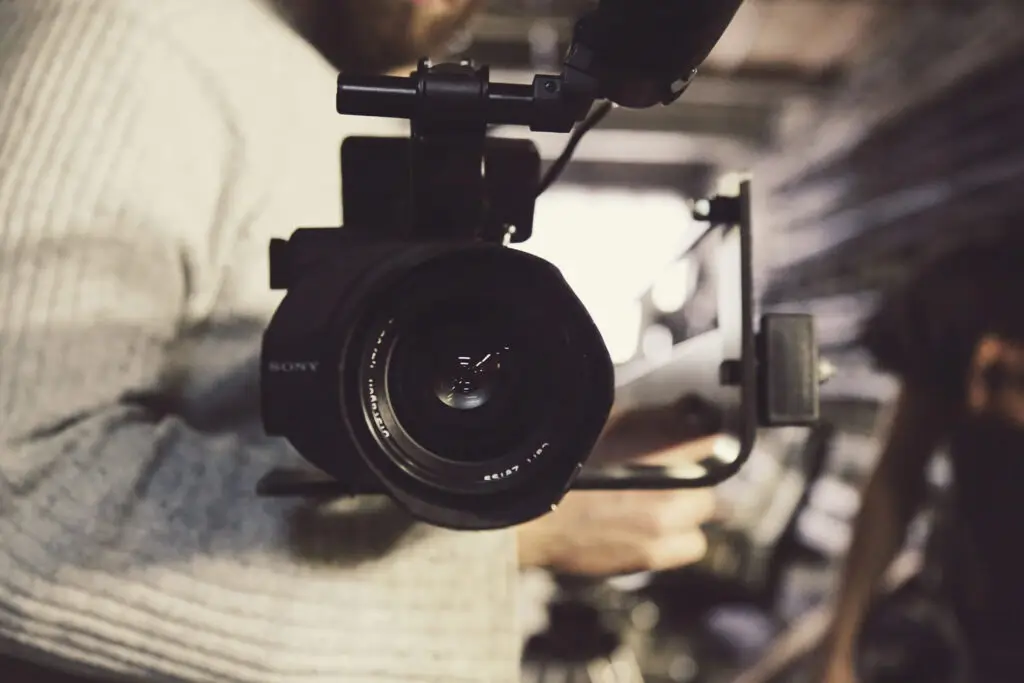 An image of someone holding a large camera representing Soulheart's blog titled Digital Marketing Trends 2024 [Breakdown].