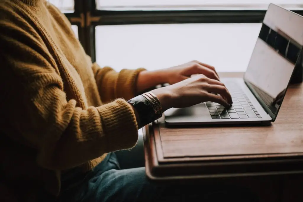 A woman on her computer representing Soulheart's blog titled Deciphering Digital Success: The Significance of Ads Training.