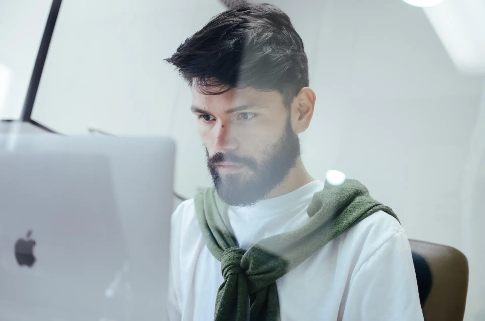 A man focusing on his computer representing Soulheart's blog titled Deciphering Digital Success: The Significance of Ads Training.