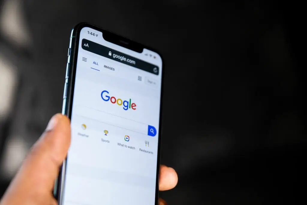 Image of a person holding a phone with the Google website up representing Soulheart's blog titled Why Your Website Design Should be Mobile Optimized: Part 1.