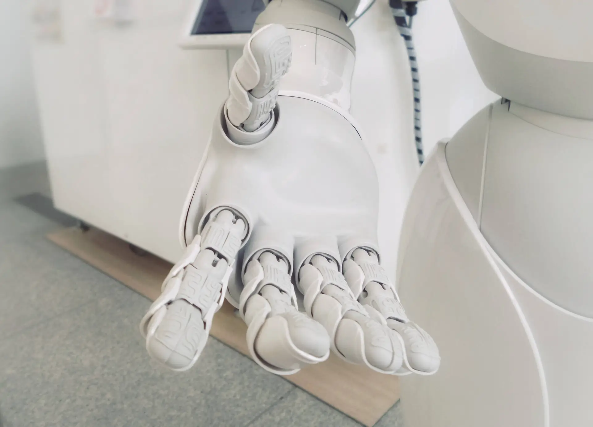 An image of a robot hand representing Soulheart's blog titled "Leveraging AI for Google Ads: A Guide for Nonprofit Organizations"|Image of the Google Ads Certification badge which is a yellow ribbon with a magnifying glass.