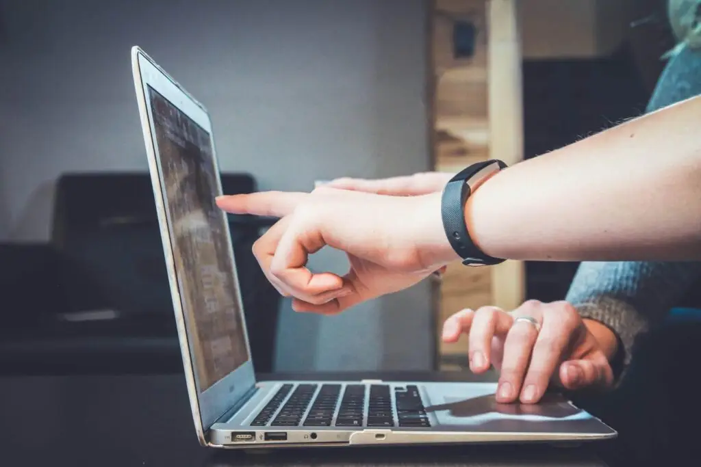 An image of someone pointing at a laptop representing Soulheart's blog about website optimizations