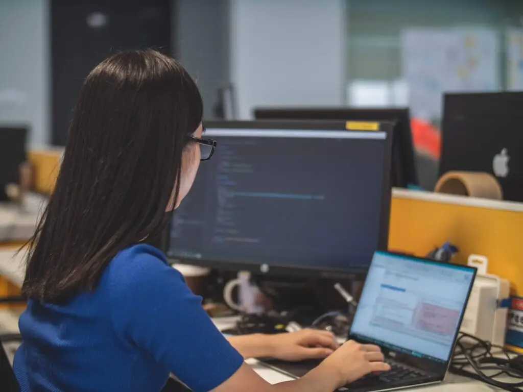 A woman on her computer representing Soulheart's blog titled Deciphering Digital Success: The Significance of Ads Training.