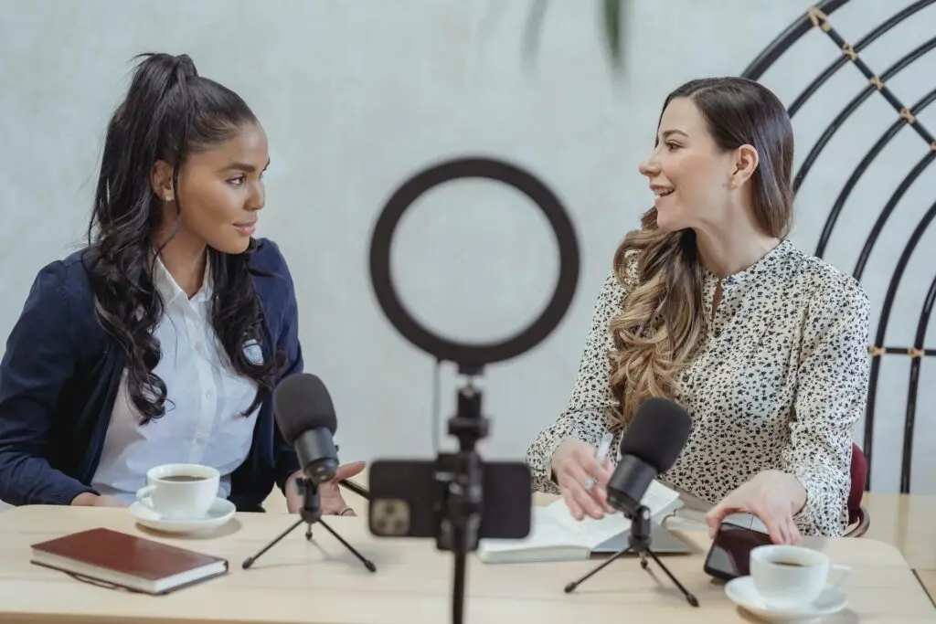 An image of two women being video taped representing Soulheart's blog titled Mastering YouTube Strategy.