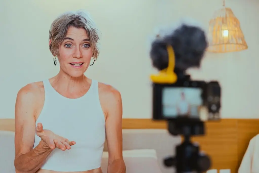 An image of a woman being video taped representing Soulheart's blog titled Mastering YouTube Strategy.