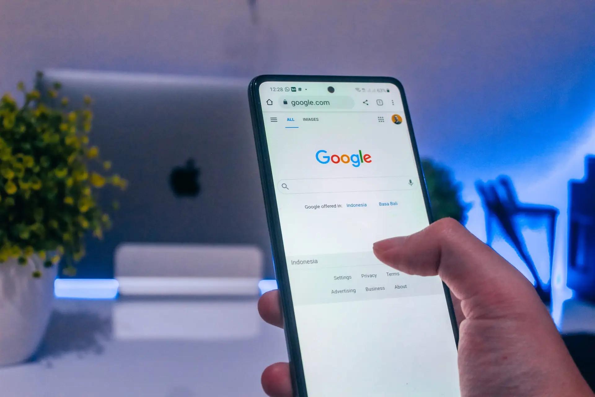 Person starting a Google search on an iPhone