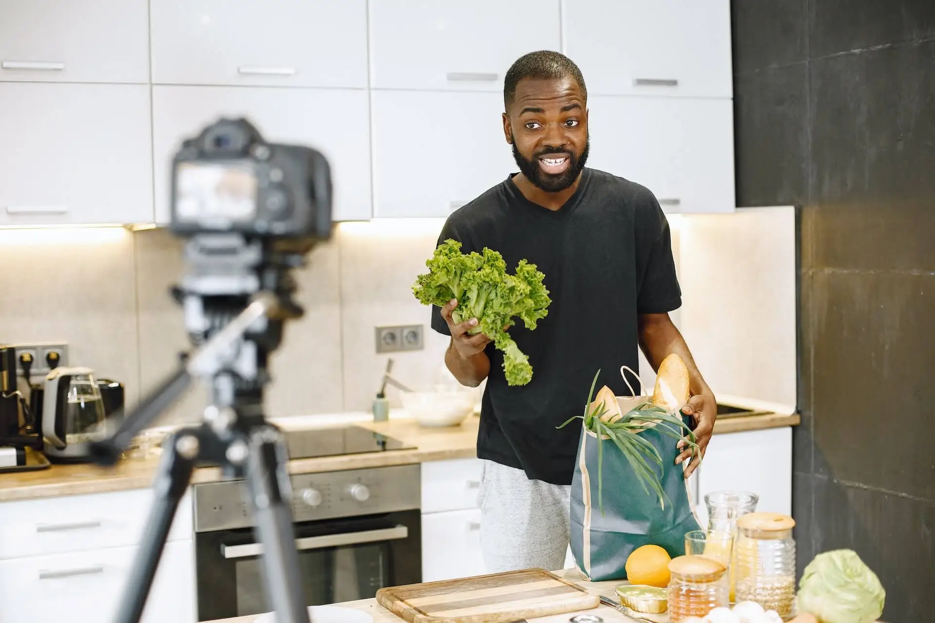 Image of a man being filmed doing a cooking tutorial, representing Soulheart's blog titled What Type of YouTube Content Should You Create as a Brand?|An image of a woman being interviewed for a video representing Soulheart's blog titled What Type of YouTube Content Should You Create as a Brand?|Image of a woman making a fashion video representing Soulheart's blog titled What Type of YouTube Content Should You Create as a Brand?|Image of a man filming himself on the beach representing Soulheart's blog titled What Type of YouTube Content Should You Create as a Brand?|