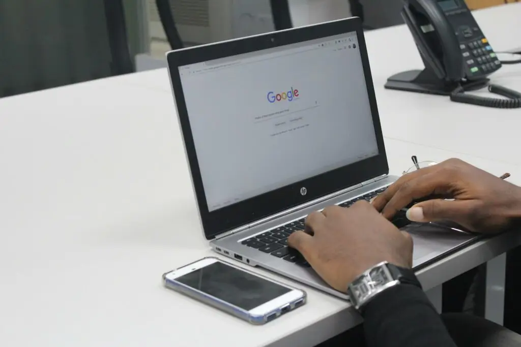 Image of a man on his laptop with Google open representing Soulheart's blog titled How Can a NonProfit Organization Apply for Google Grant Ads?