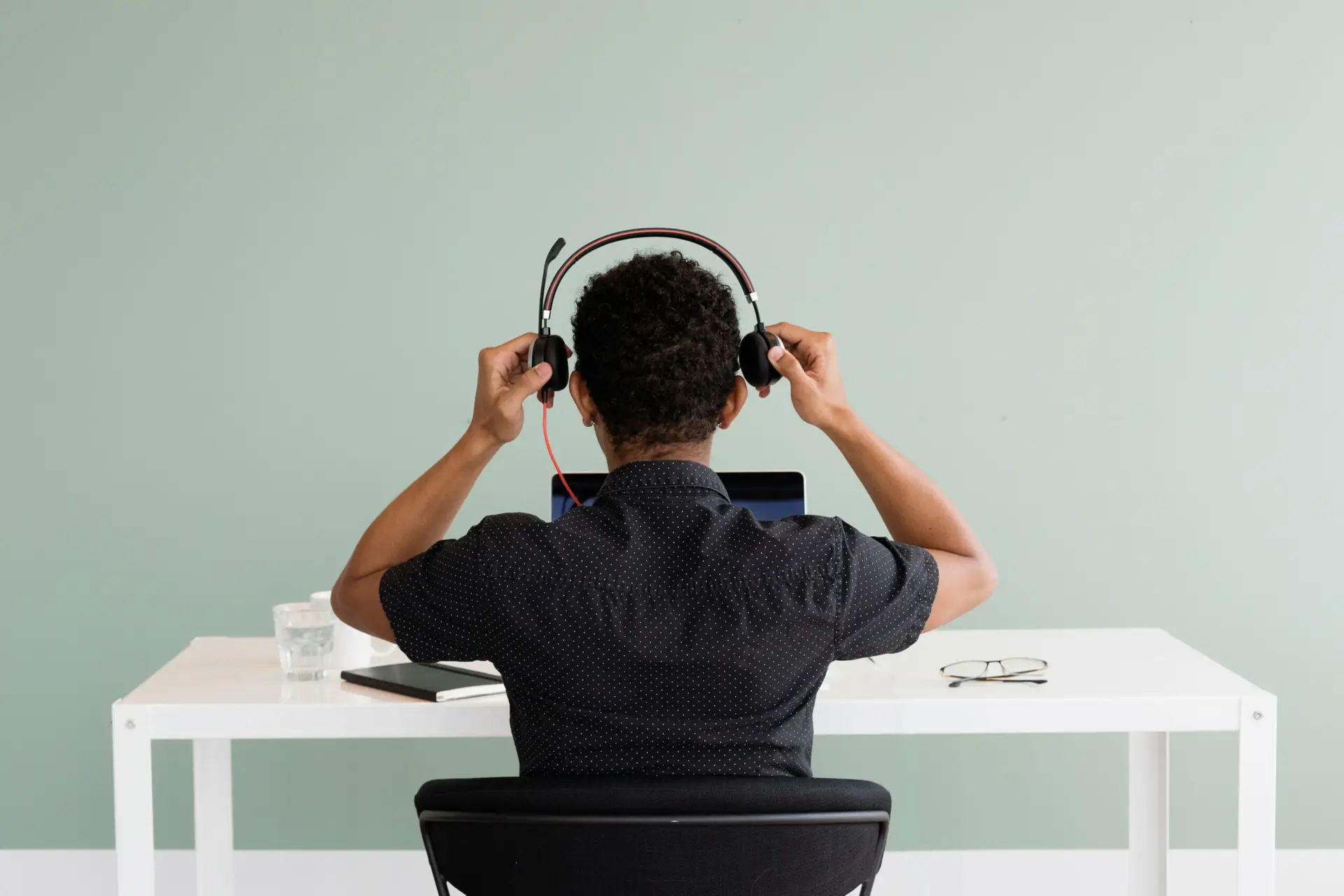 Sales representative putting on a headset representing Soulheart's blog titled Unlocking the Power of HubSpot's Sales Hub [What Business Owners Need to Know]