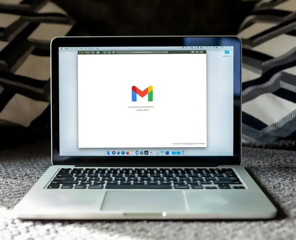 An image of a laptop with  Gmail loading representing Soulheart's blog titled Google's DMARC Update [Business Email Deliverability Impact]