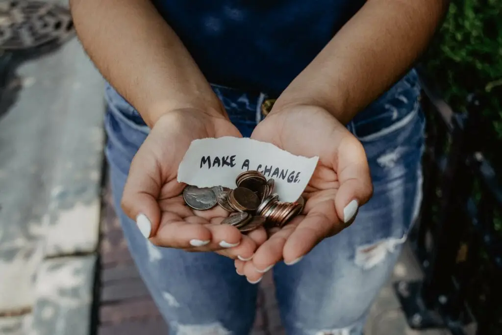 Image of a woman holding coins and a paper that reads make a change representing Soulheart's blog titled Skyrocket Your Results with Soulheart's Advanced SEO Services.
