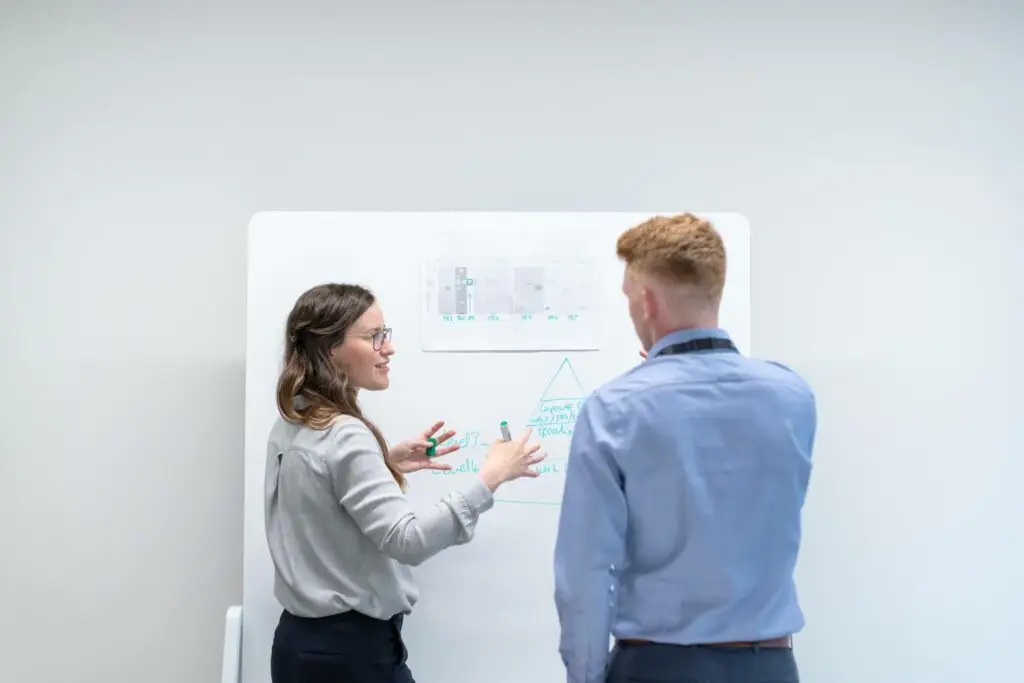 An image of two business people have a meeting representing Soulheart's blog A Nonprofit's Comprehensive Guide on Google Ads.