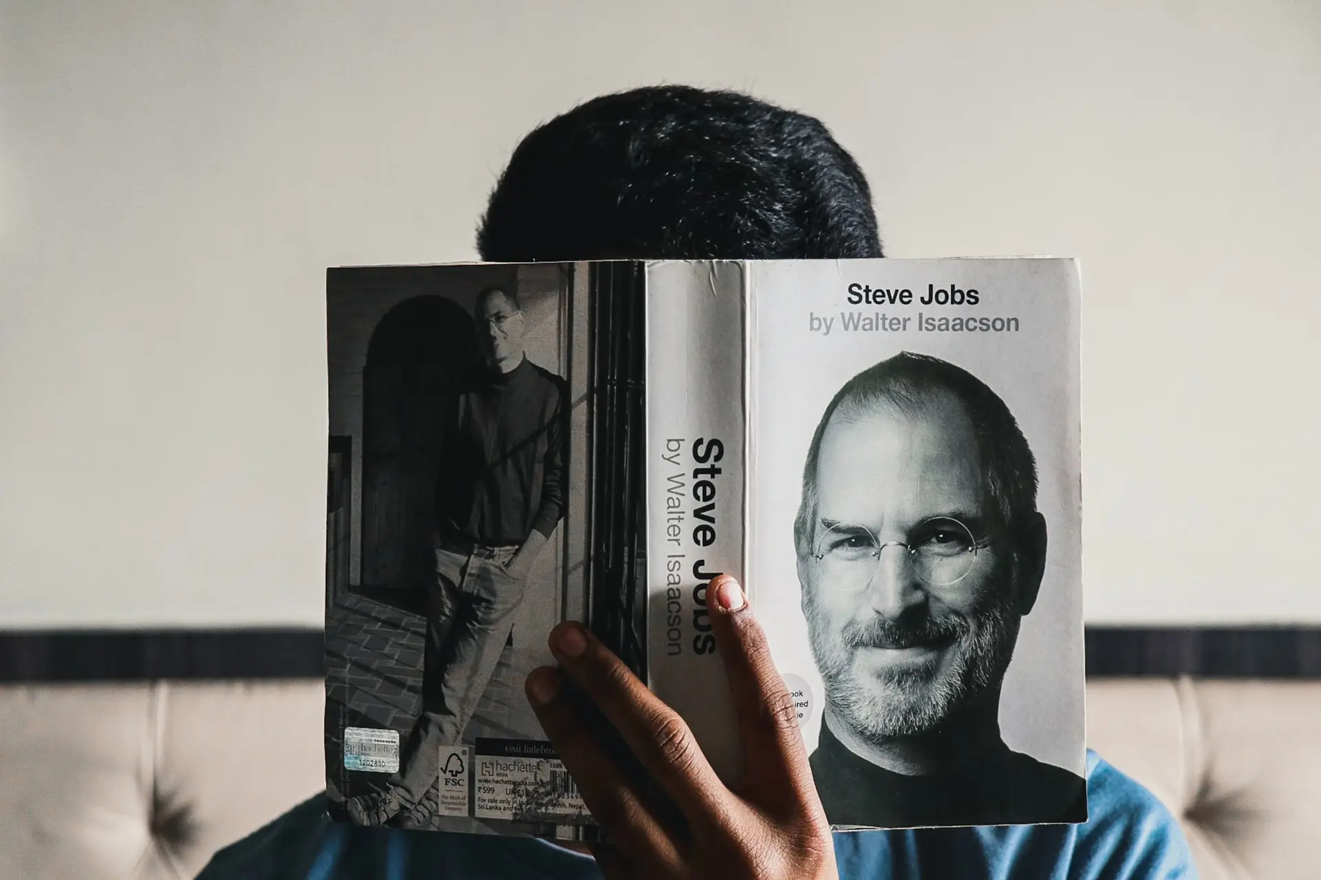 Man holding a book about Steve Jobs