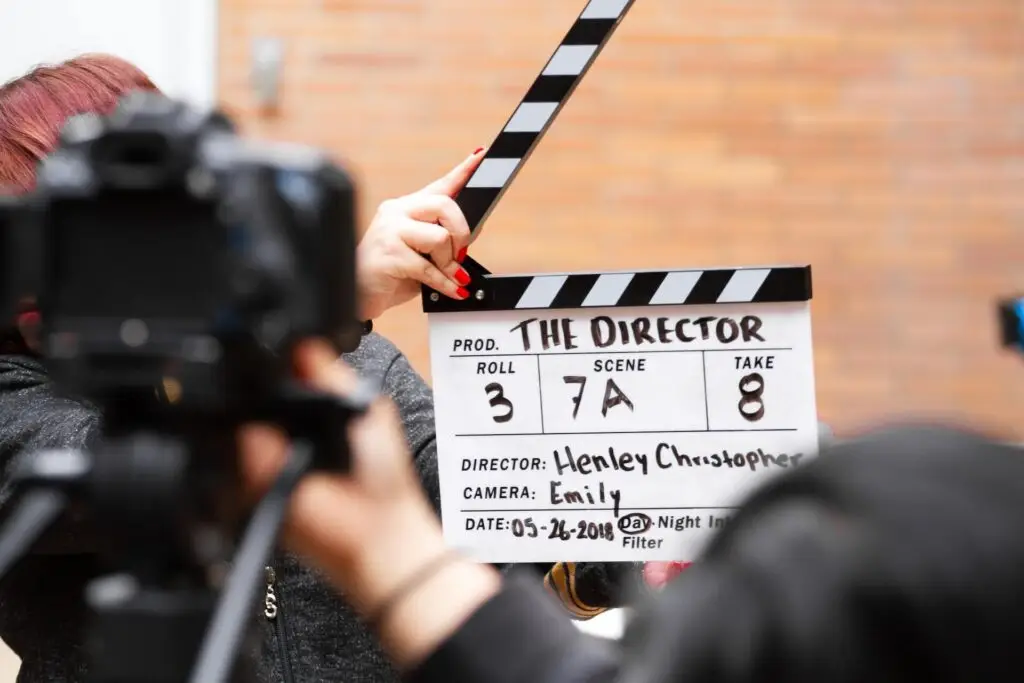 An image of a assistant director clapping a film slate representing Soulheart's blog titled YouTube Bumper Ads: Captivating Audiences in a Snap.