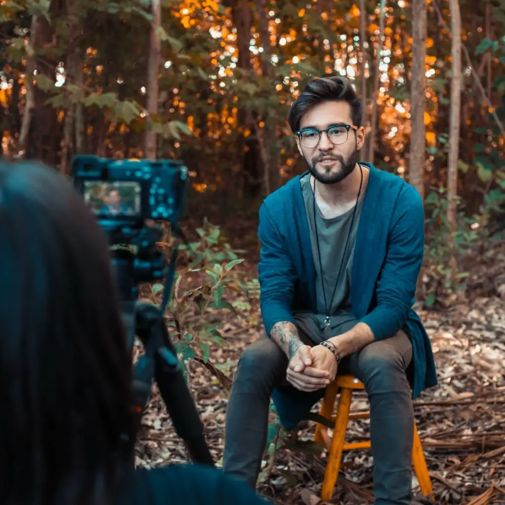 An image of a man being filmed representing Soulheart's blog titled Mastering YouTube Strategy.