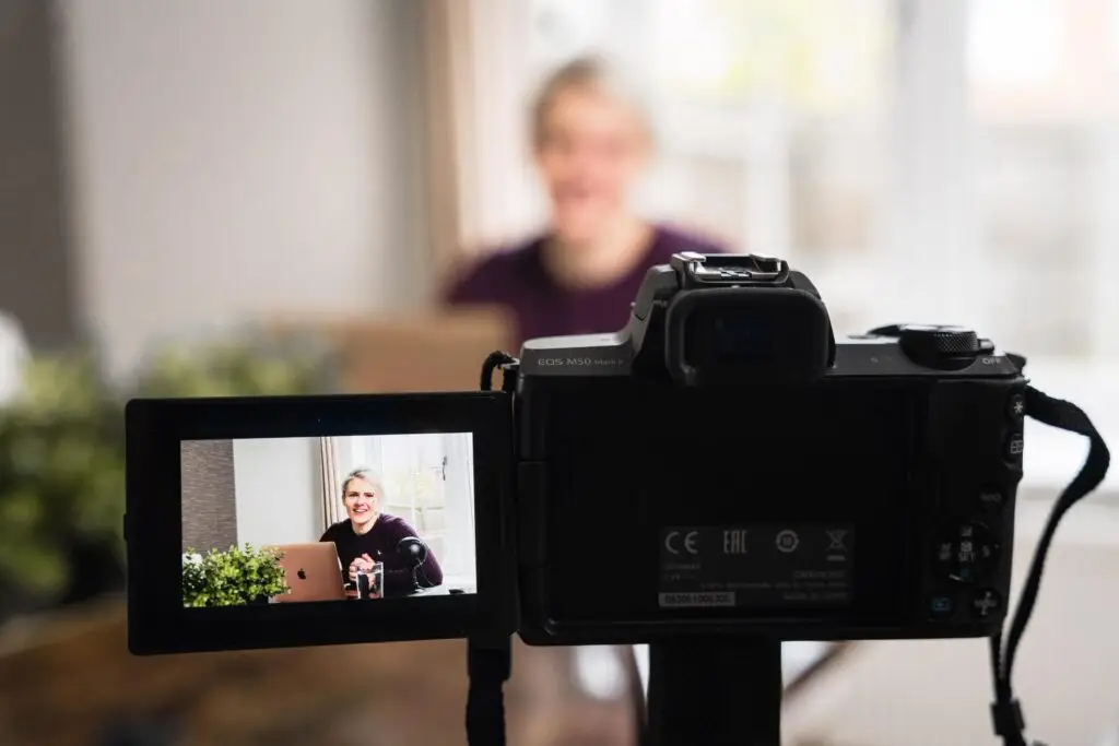 An image of a woman filming a video, representing Soulheart's blog teaching people how to succeed on YouTube.