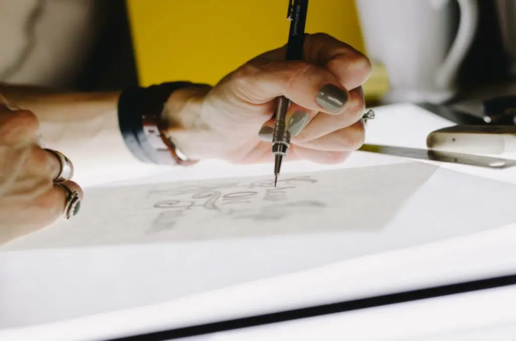 Image of a designer sketching representing Soulheart's blog titled "Google Ad Grants Not Approved? Here's What To Do Next!" which is an article about nonprofit google ads.
