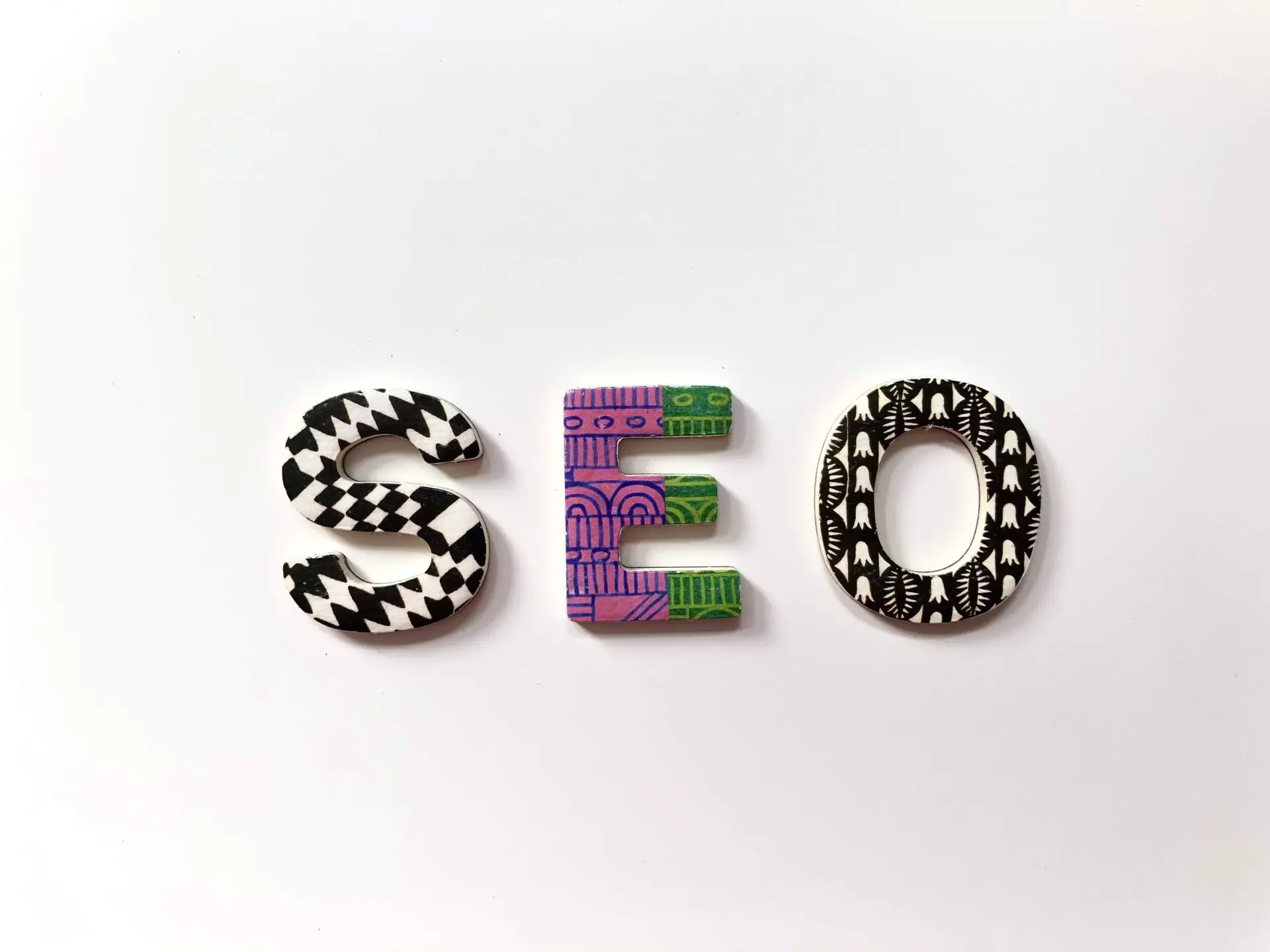 Image of the letters SEO with some unque designs on them used for Soulheart's blog on SEO Training.||An image of a laptop open with Google on it representing Soulheart's blog titled SEO Training for Success: Amplify Your Skills Today.||An image of a woman taking notes in front of her laptop representing Soulheart's blog titled SEO Training for Success: Amplify Your Skills Today.|An image of a man in front of his computer putting on a a headset representing Soulheart's blog titled SEO Training for Success: Amplify Your Skills Today.
