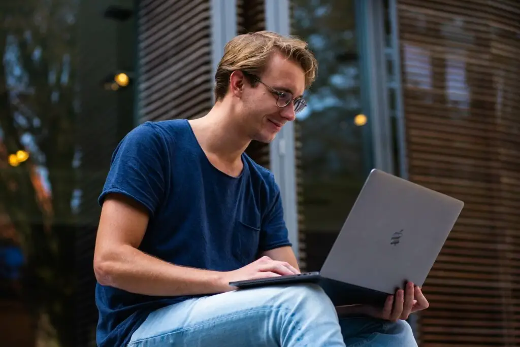 Image of a man in front of his laptop representing Soulheart's blog titled Optimizing Your Blog for Search Engines.