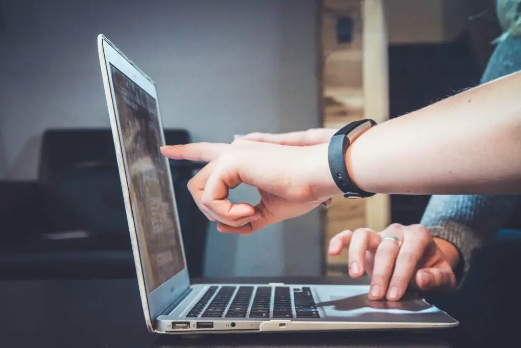 An image of someone pointing at a laptop representing the blog Beyond the Pretty Pixels Digital Marketing Training For Designers.