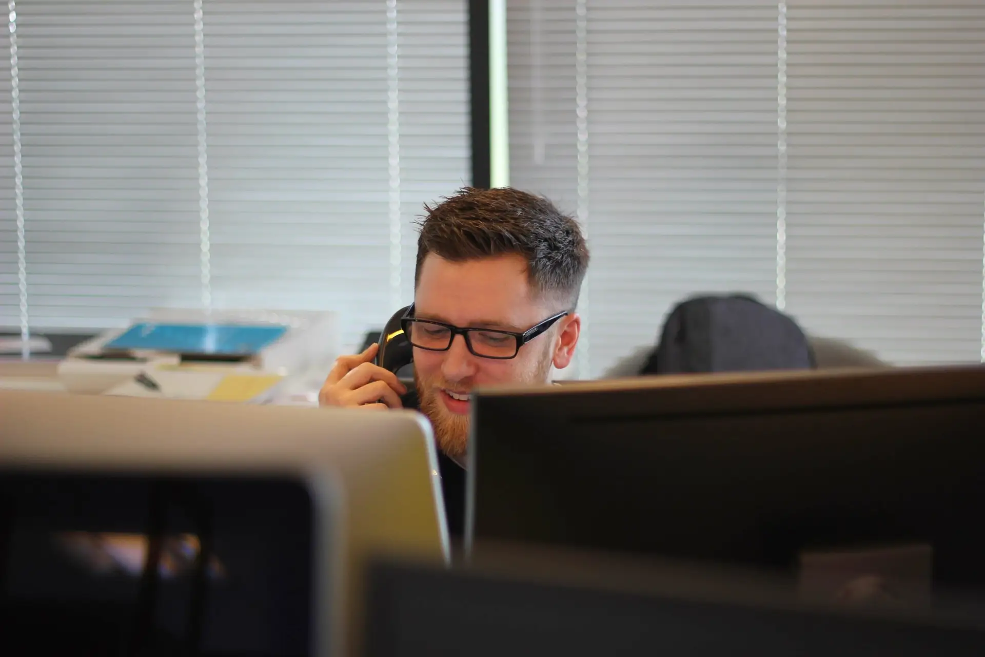 Customer service employee talking on the phone representing Soulheart's blog titled How HubSpot's Service Hub Drives Customer Satisfaction and Business Growth