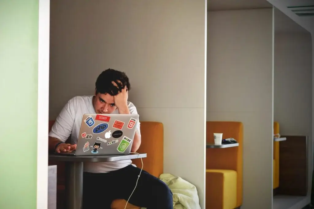 A man in front of his laptop, frustrated, representing Soulheart's blog on digital marketing training and digital marketing education.