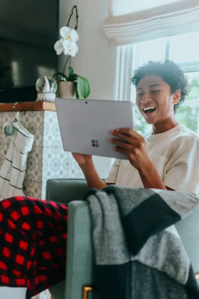 An image of a man watching a video on his tablet representing Soulheart's blog titled Visibility Counts: How YouTube SEO Delivers Success [Guide].