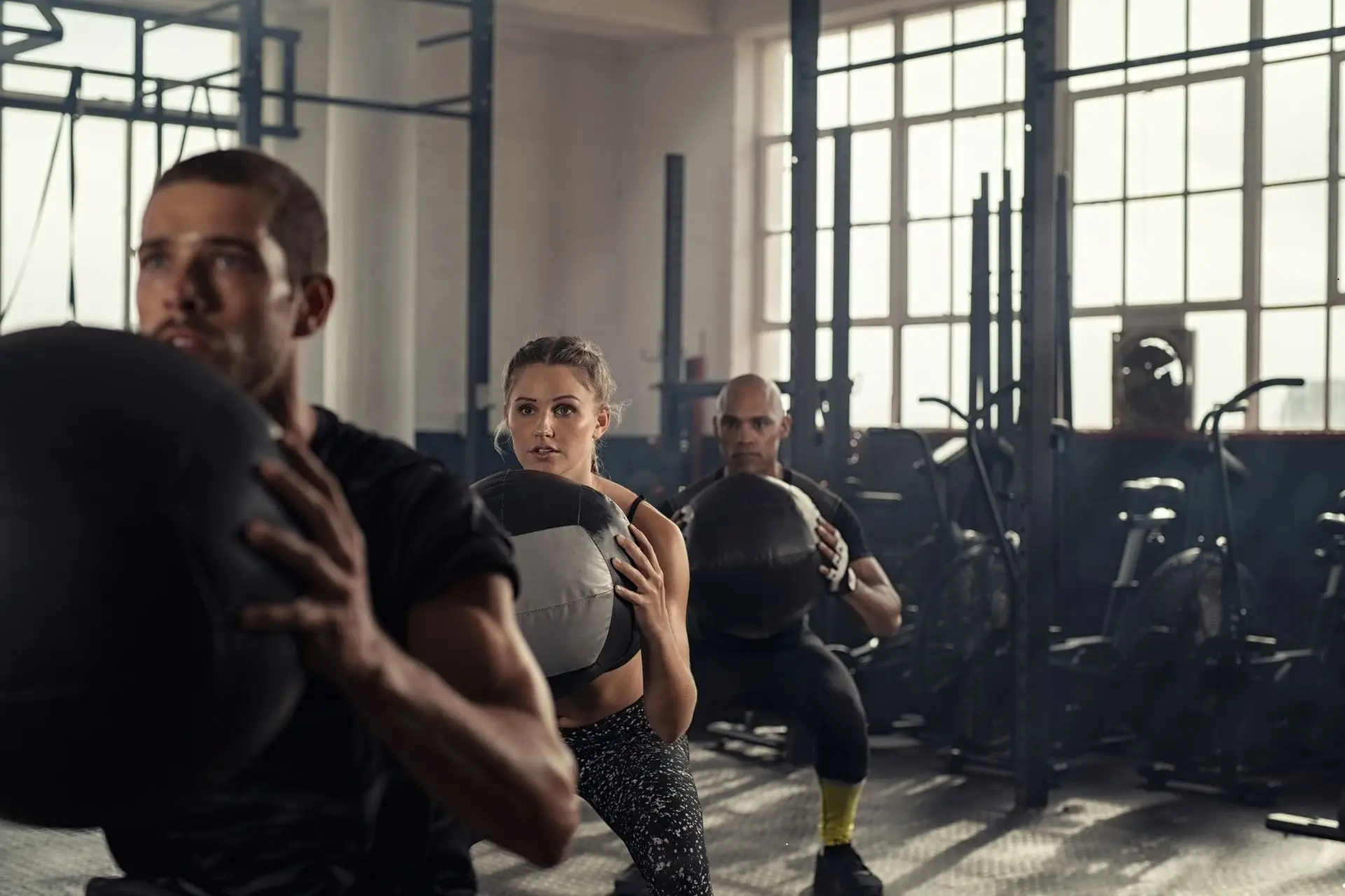 Image of people working out at a CrossFit gym representing an article about Webflow for CrossFit gyms. WebFlow is a no-code website builder and CrossFit gyms should use it for their website.