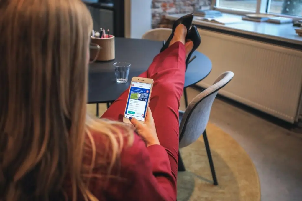 Image of a woman looking at her phone representing Soulheart's blog titled Google Grant Ads for Nonprofit Organizations.