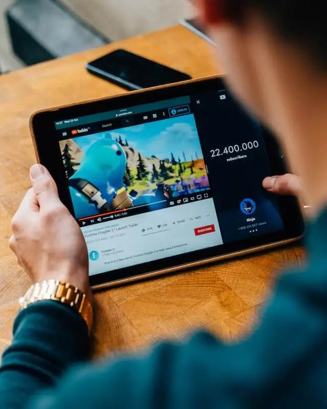 An image of a man watching a YouTube video representing Soulheart's blog titled YouTube Ads 101.
