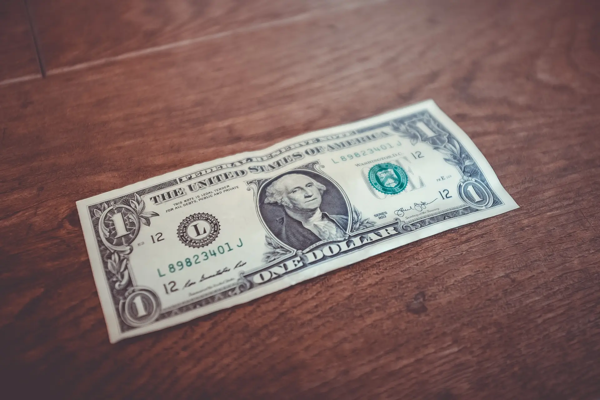 A $1 bill sitting on a table
