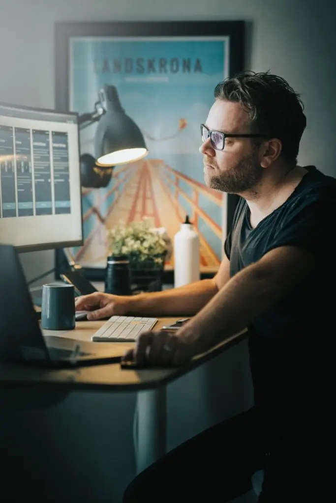 Image of a man sitting at his desk designing a website. The image is used to represent Soulheart's article about the Soulheart Circle digital marketing training for Designers.