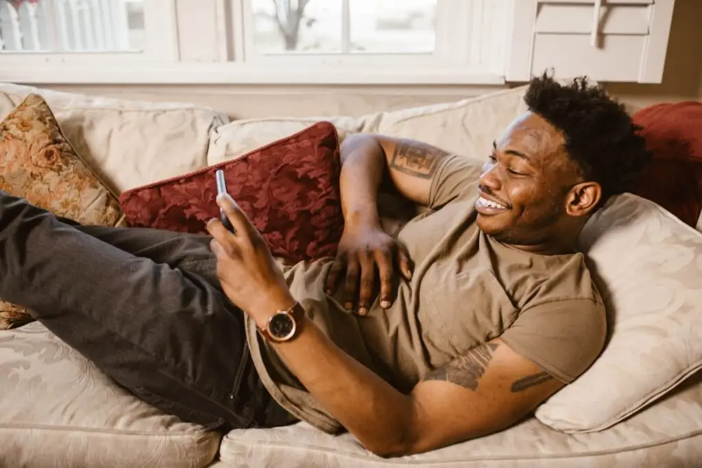 An image of a man watching a video on his phone representing Soulheart's blog titled YouTube Bumper Ads: Captivating Audiences in a Snap.